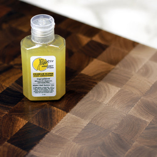 Windset Studio 2 oz board conditioner bottle on a walnut end-grain board; the kit also includes an applicator cloth, not pictured