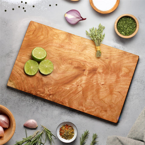 Cherry one-piece cutting board with warm reddish wood grain