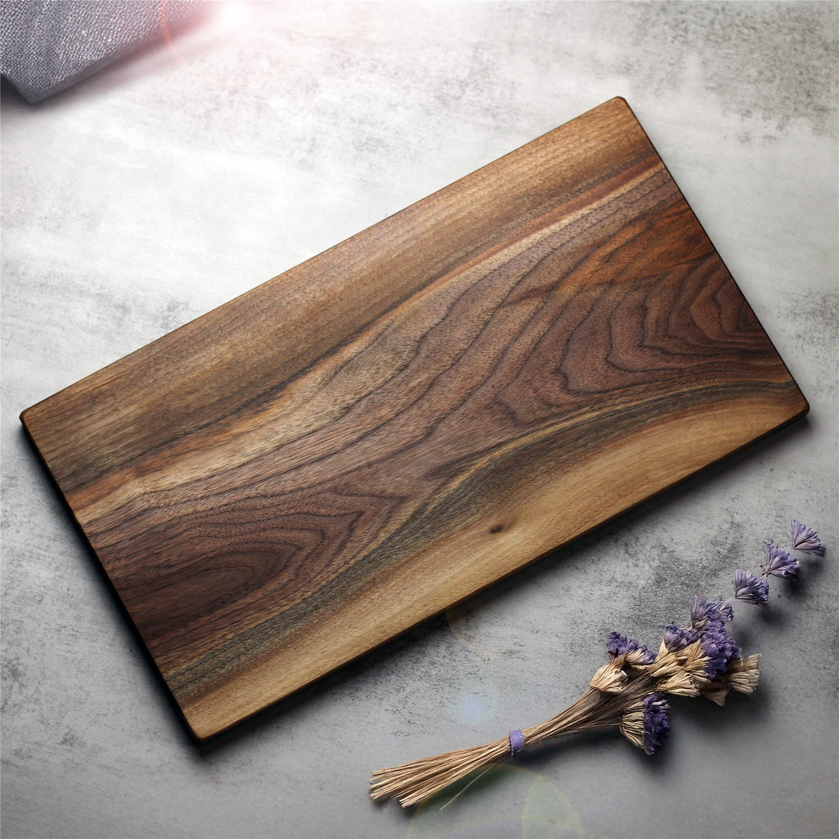 Walnut cutting board made from one solid piece, showing its natural grain and lighter sapwood